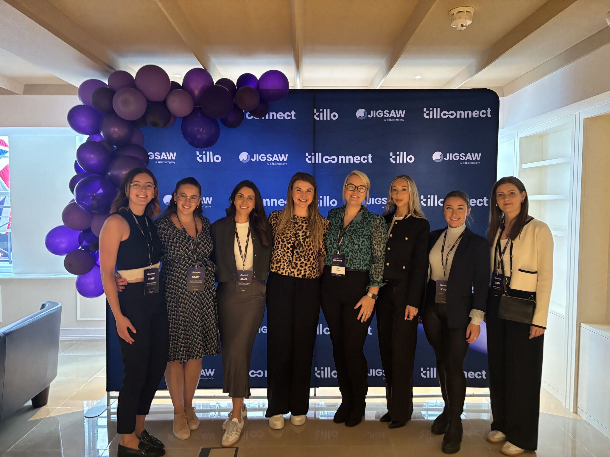 The Jigsaw team together at an event, eight women stand together smiling